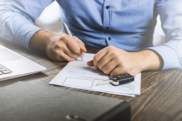 Man filling out car paperwork